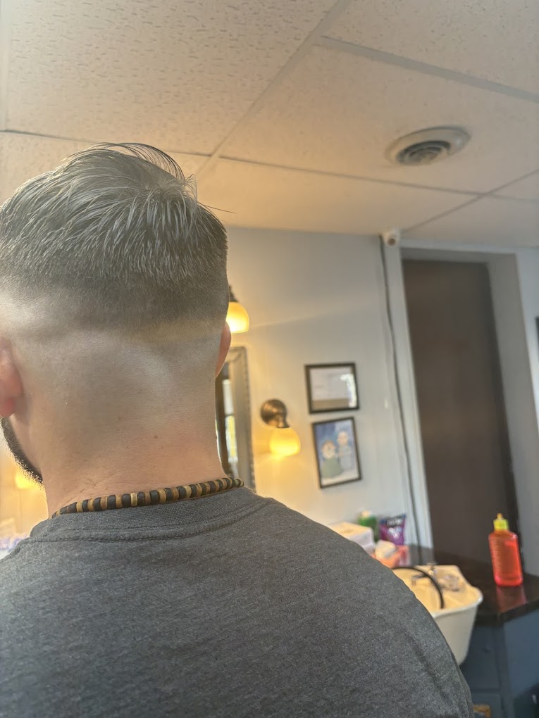Clean taper fade from behind — Grandville Barbershop